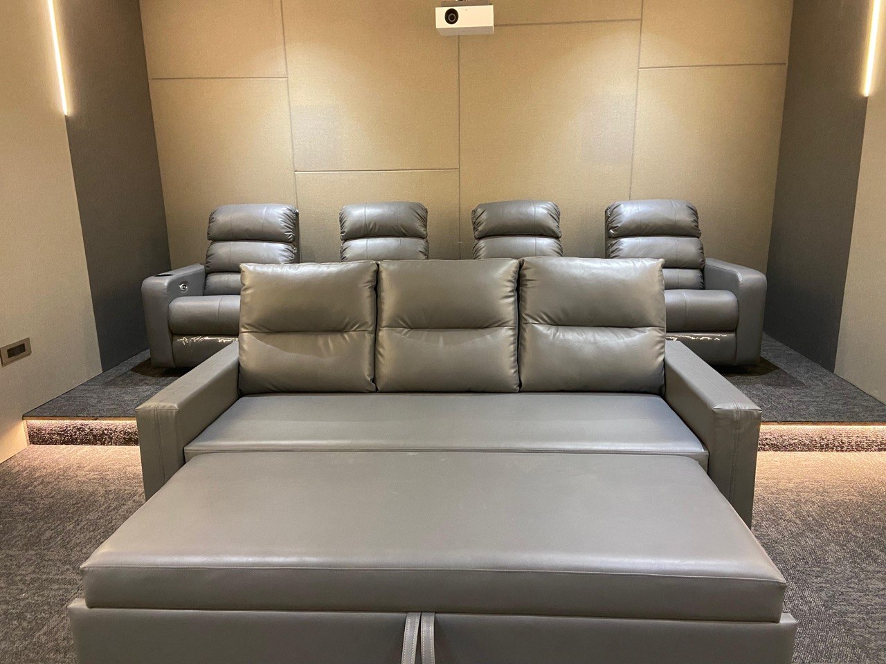 Cinema seating — grey leather recliners with ottoman