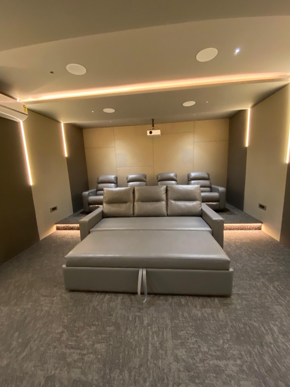 Cinema seating — tiered recliner layout with projector