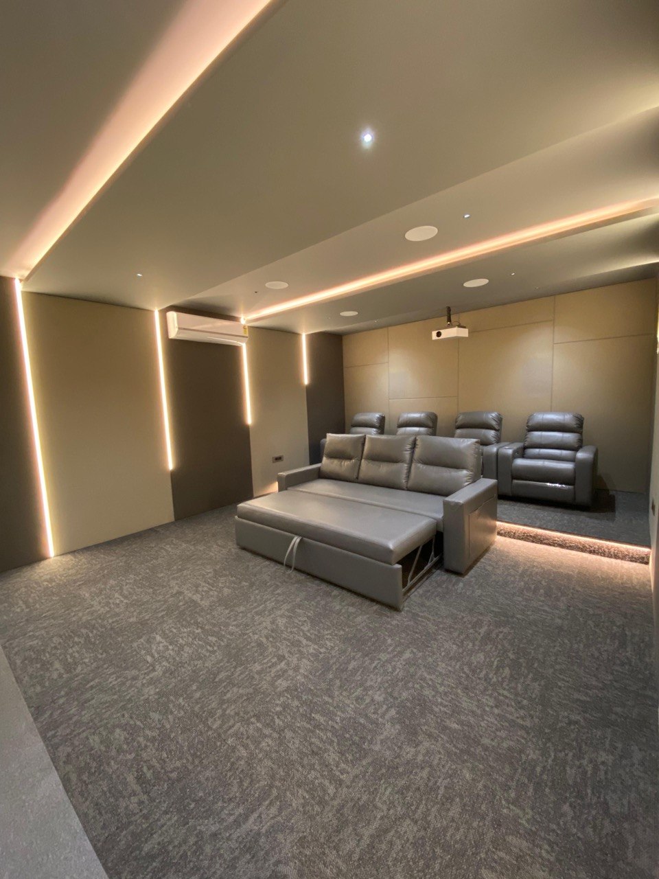Cinema seating — full room side-angle with LED wall strips